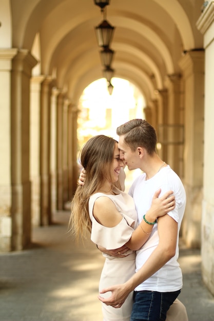 Happy young couple walking outdoors in old town