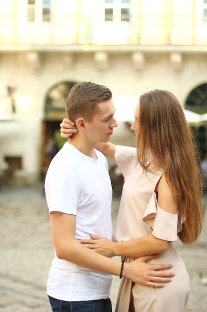 Happy young couple walking outdoors in old town