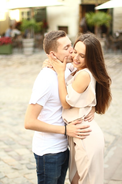 Happy young couple walking outdoors in old town