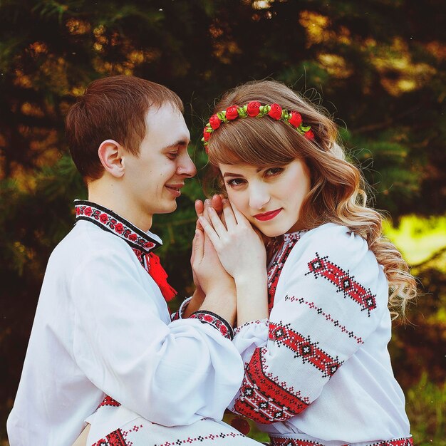 Happy young couple walking in spring park. Embroidery. Sunset. Family look. Lifestyle. Date. Love