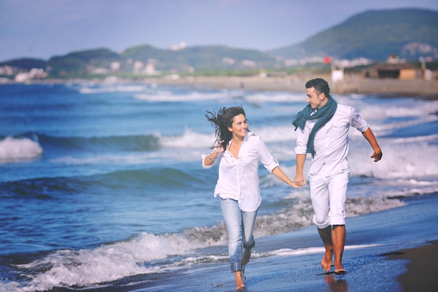 happy young couple in white clothing  have romantic recreation and   fun at beautiful beach on  vacations