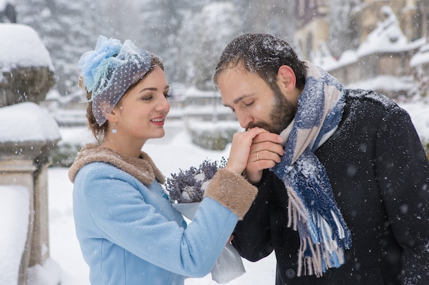 Happy Young Couple in Winter Park. Family outdoors at the castle.