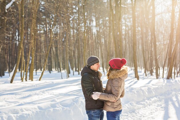 Happy Young Couple in Winter Park having fun. Family Outdoors. love