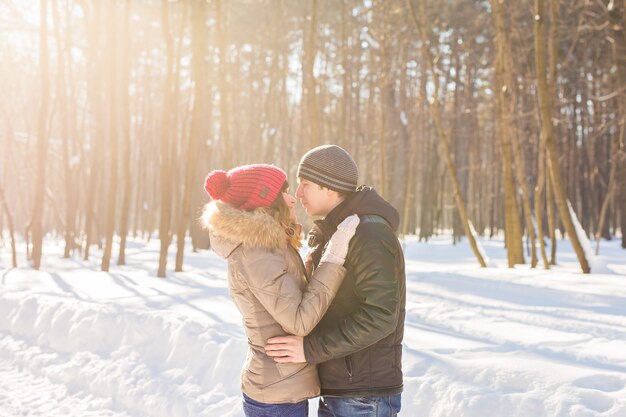 Happy Young Couple in Winter Park having fun. Family Outdoors. love