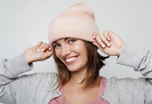 Happy young emotional woman wearing pink hat