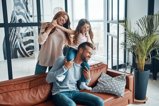 Happy young family bonding together at home