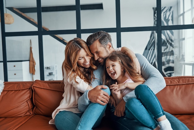 Happy young family bonding together at home