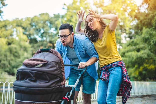 Happy young family enjoying together in park.