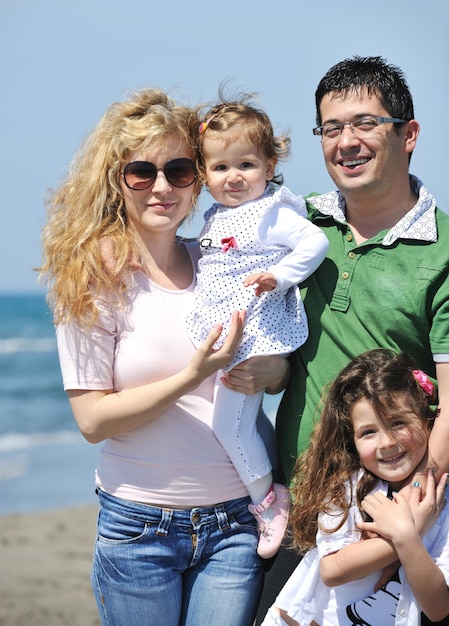 happy young family have fun and live healthy lifestyle on beach