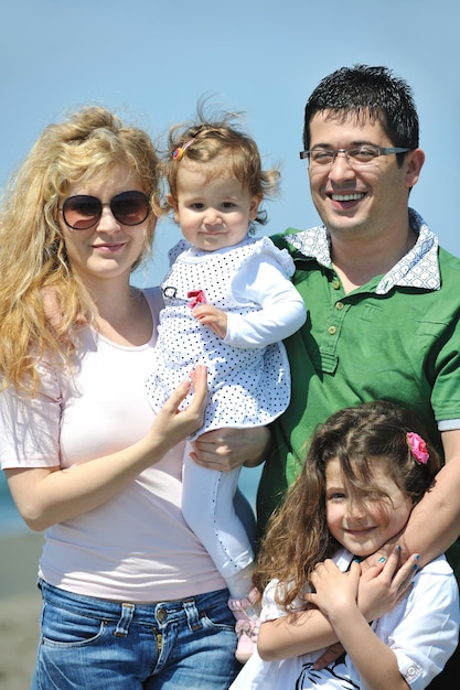 happy young family have fun and live healthy lifestyle on beach