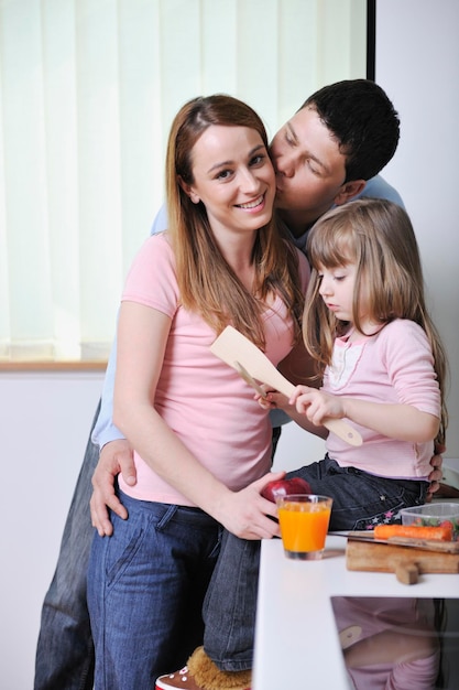 happy young family have lunch time with fresh fruits and vegetable food in bright kitchen