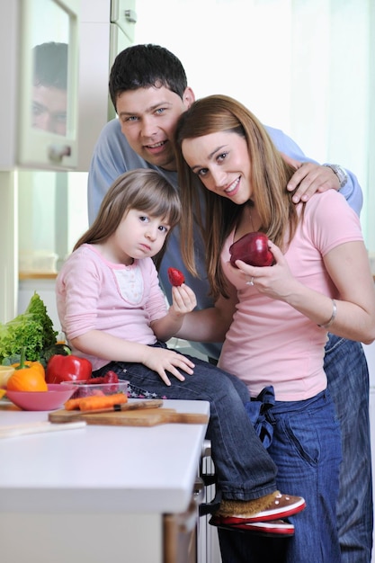 happy young family have lunch time with fresh fruits and vegetable food in bright kitchen