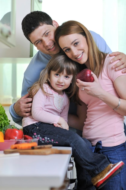 happy young family have lunch time with fresh fruits and vegetable food in bright kitchen