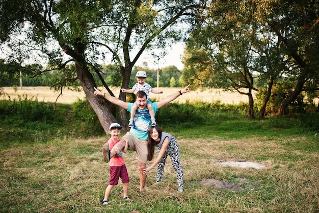 Happy young family mother father two children son on nature having fun