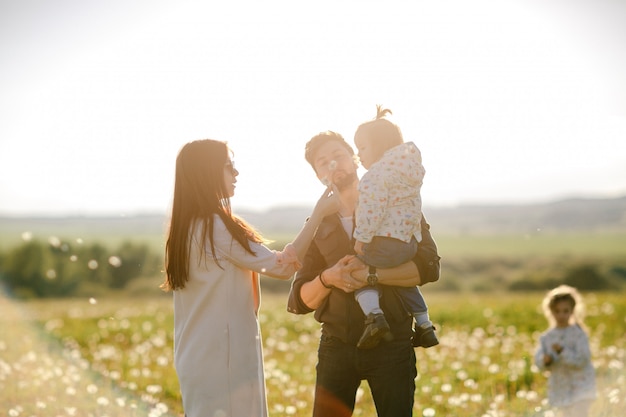 happy young family spending time outdoor on a summer day