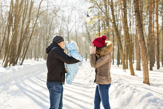 Happy young family spending time outdoor in winter.