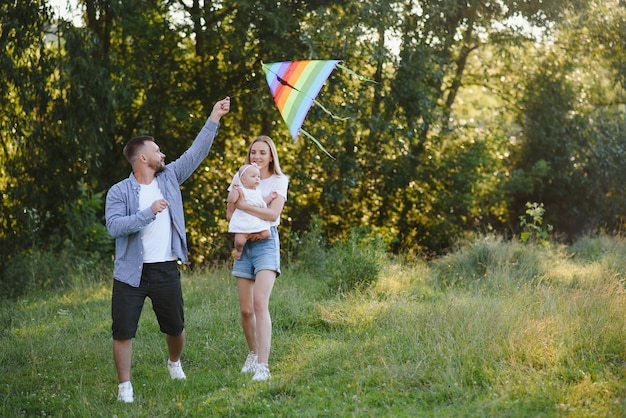 Happy young family spending time together outside in green nature.