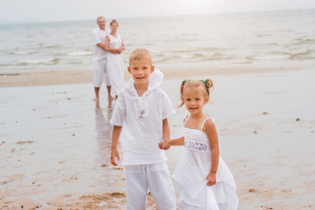 Happy young family on the sunset at the beach.