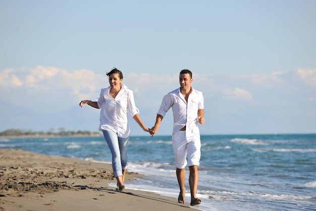 happy young family in white clothing have fun at vacations on beautiful beach