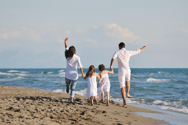 happy young family in white clothing have fun at vacations on beautiful beach