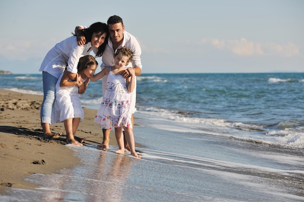 happy young family in white clothing have fun at vacations on beautiful beach