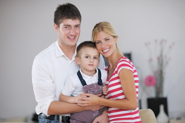 happy young family with kids in bright modern living room have fun and looking big flat lcd tv