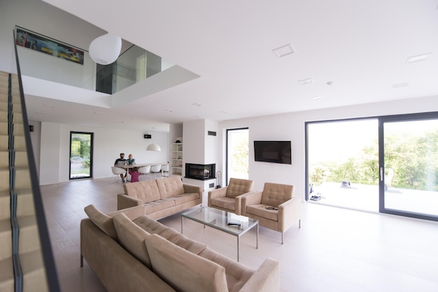 happy young family with little girl enjoys in the modern living room of their luxury home villa