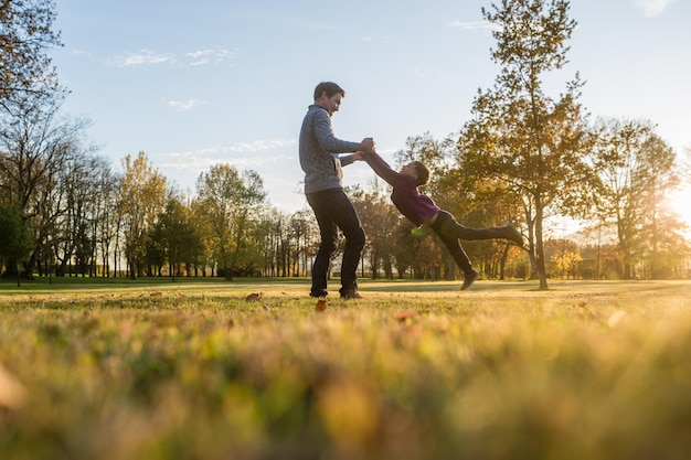 Happy young father playing with his toddler son