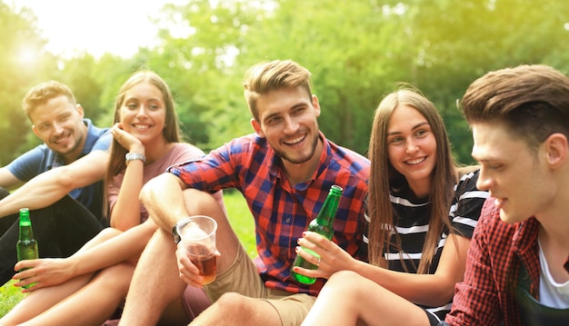 Happy young friends enjoying picnic and eating