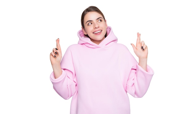 Happy young girl in pink hoodie make a wish isolated on white background