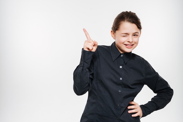 Happy young girl posing and pointing