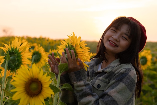 Happy young girl at sunflower field with blue sky