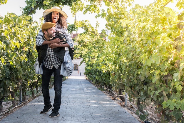 Happy young interracial couple on holiday in a vineyardxA