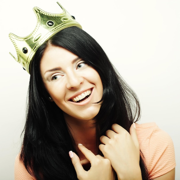 Happy young lovely woman with crown