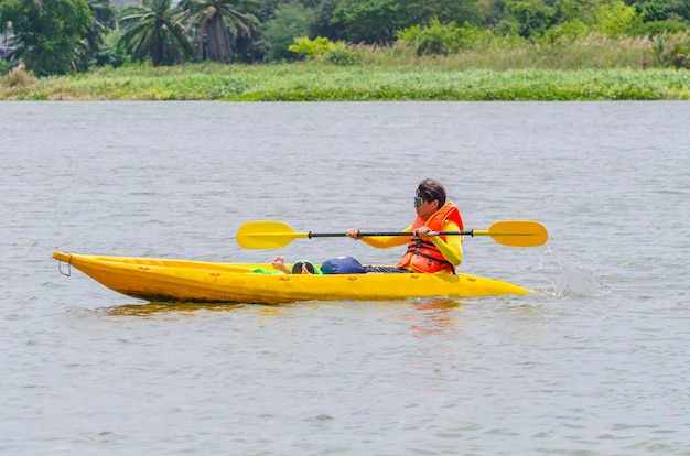 Happy young man canoeing in a lake