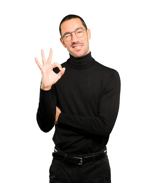 Happy young man doing an all right gesture