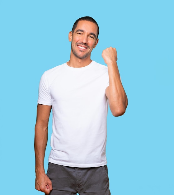 Happy young man doing a competitive gesture