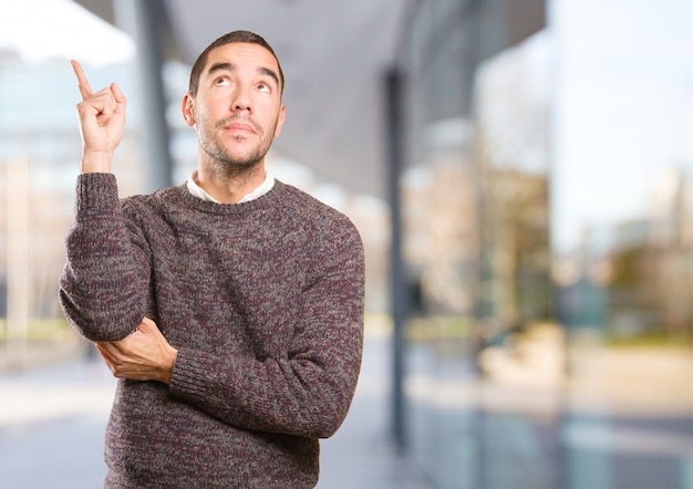 Happy young man doing a gesture of show