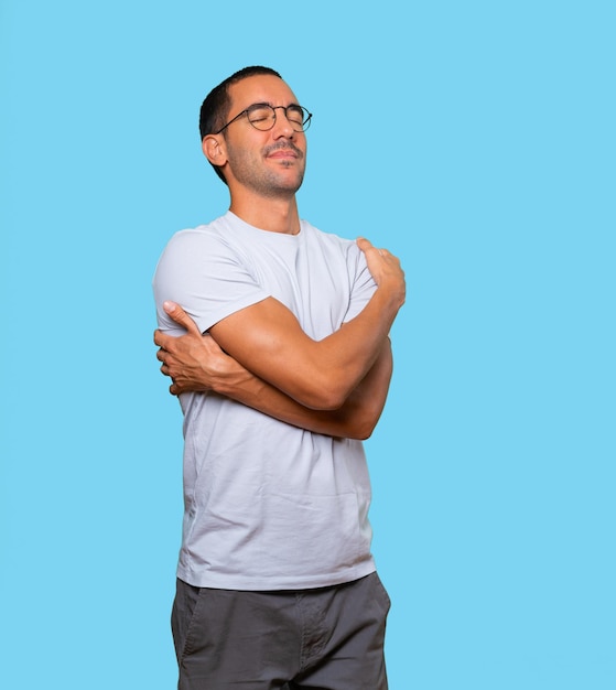 Happy young man doing a hug gesture