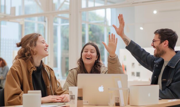 Happy young man giving a high five to a woman during a meeting in the office