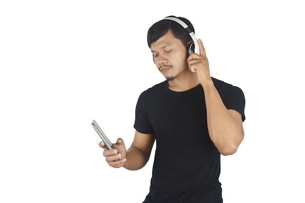 Happy young man listening to music with headphones on white background copy space