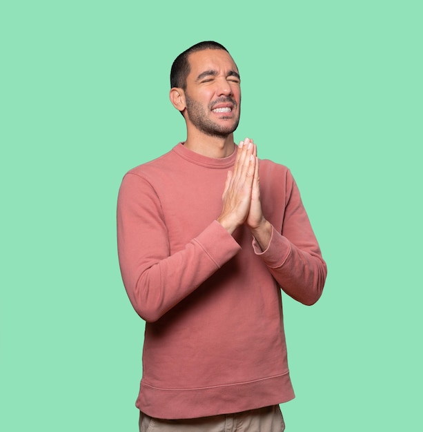 Happy young man praying gesture