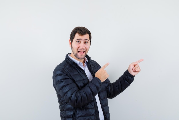 Happy young man showing the right with fingers on white background