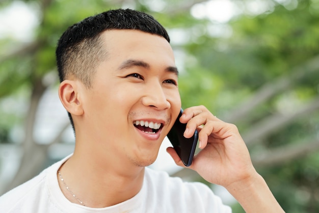 Happy young man talking on phone