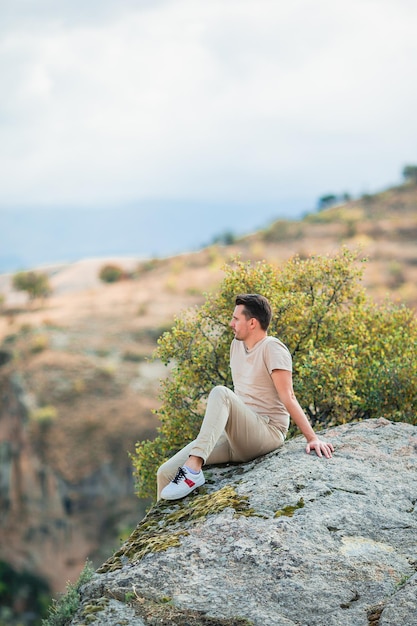 Happy young man watching hot air balloons in cappadocia turkey