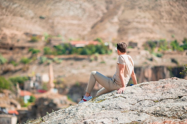 Happy young man watching hot air balloons in cappadocia turkey