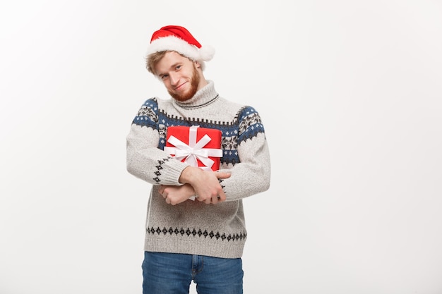 Happy young man with beard carries present isolated on white