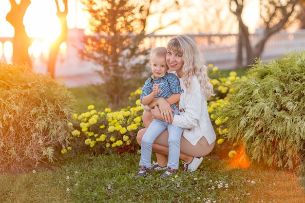 Happy young mother having fun with her child in summer sunny day Family lifestyle