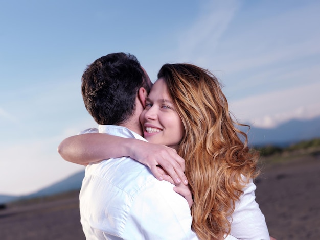 happy young romantic couple in love have fun on beautiful beach at beautiful summer day