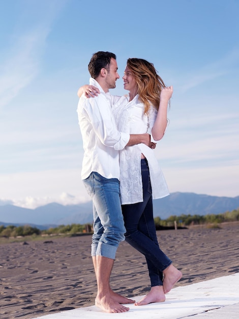 happy young romantic couple in love have fun on beautiful beach at beautiful summer day